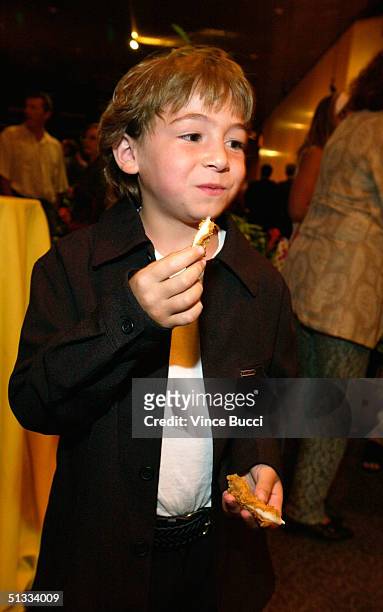 Actor Jonah Bobo has a snack at the After Party for the premiere of Warner Bros. "Around the Bend" at the DGA on September 21, 2004 in Hollywood,...
