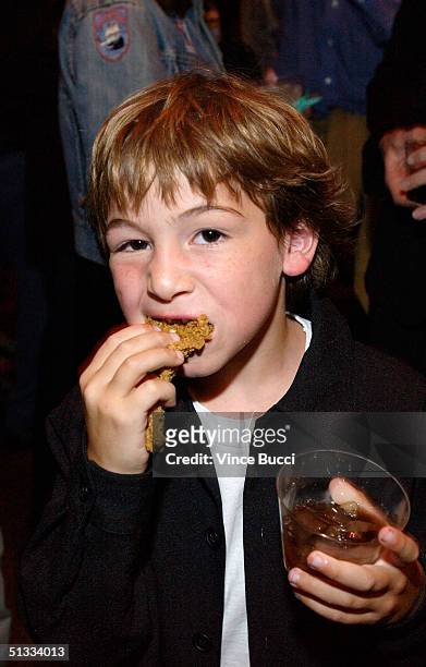 Actor Jonah Bobo has a snack at the After Party for the premiere of Warner Bros. "Around the Bend" at the DGA on September 21, 2004 in Hollywood,...