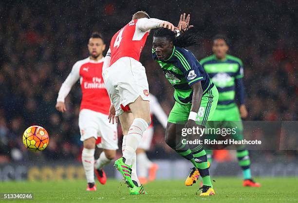 Bafetimbi Gomis of Swansea City battles for the ball with Per Mertesacker of Arsenal during the Barclays Premier League match between Arsenal and...