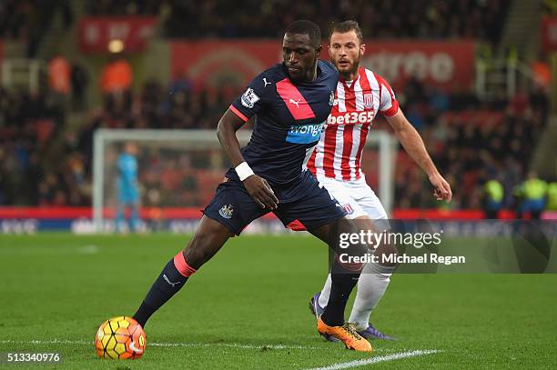 Moussa Sissoko of Newcastle United holds off Erik Pieters of Stoke City during the Barclays Premier League match between Stoke City and Newcastle...