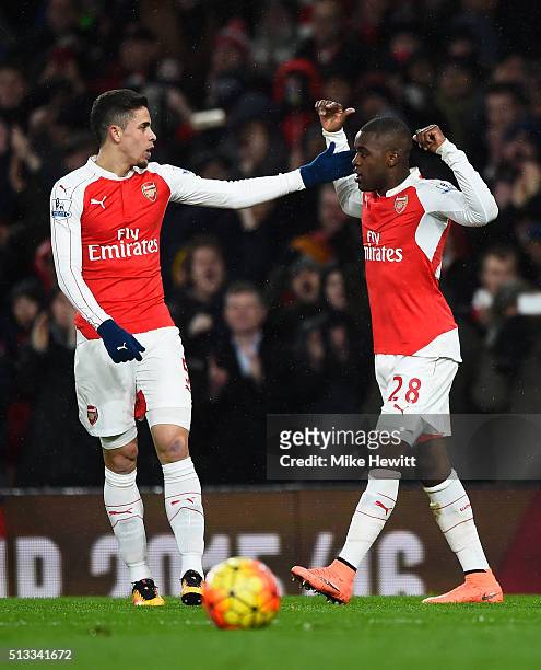 Joel Campbell of Arsenal celebrates with Gabriel after scoring the opening goal during the Barclays Premier League match between Arsenal and Swansea...