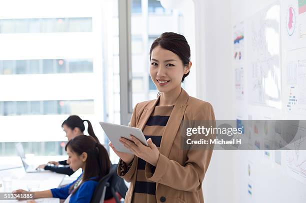 businesswomen talking in office - michael virtue stock pictures, royalty-free photos & images