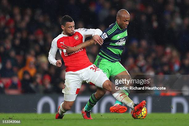 Francis Coquelin of Arsenal tackles Andre Ayew of Swansea City during the Barclays Premier League match between Arsenal and Swansea City at the...