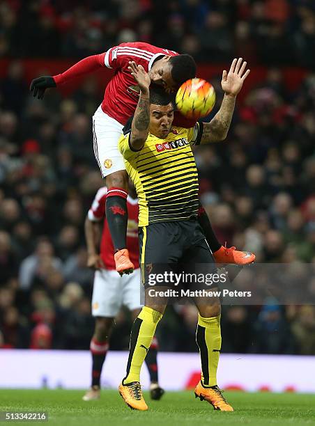 Anthony Martial of Manchester United in action with Troy Deeney of Watford during the Barclays Premier League match between Manchester United and...