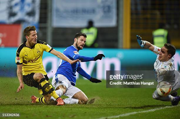 Erik Durm of Dortmund scores his team's second goal past Marcel Heller of Darmstadt and goalkeeper Christian Mathenia of Darmstadt during the...