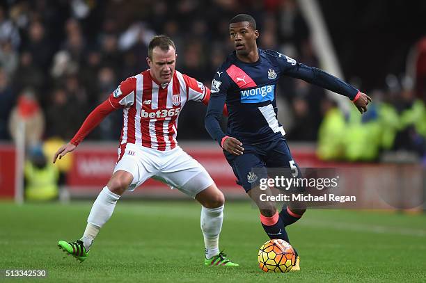 Glenn Whelan of Stoke City and Georginio Wijnaldum of Newcastle United in action during the Barclays Premier League match between Stoke City and...