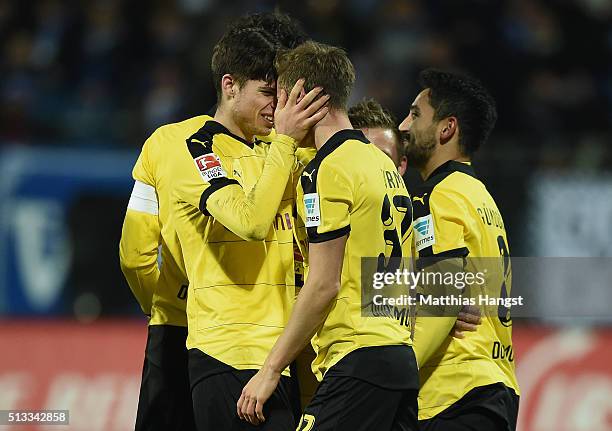 Erik Durm of Dortmund celebrates with his team-mate Julian Weigl of Dortmund after scoring his team's second goal during the Bundesliga match between...