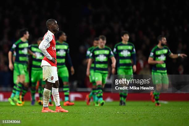Joel Campbell of Arsenal stands dejected after Wayne Routledge of Swansea City scored the equalising goal during the Barclays Premier League match...