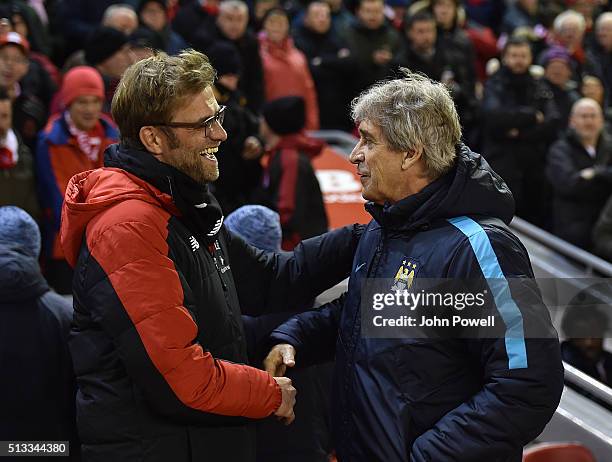 Jurgen Klopp manager of Liverpool and Manuel Pellegrini manager of Manchester City hug and shake hands before the Barclays Premier League match...