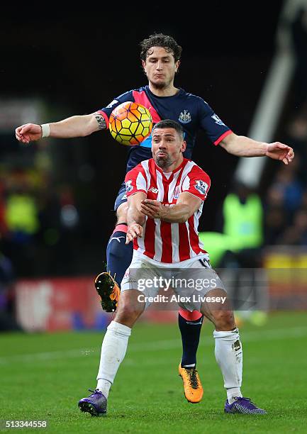 Jonathan Walters of Stoke City holds off Daryl Janmaat of Newcastle United during the Barclays Premier League match between Stoke City and Newcastle...