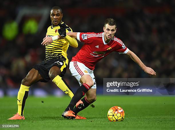 Odion Ighalo of Watford challenges Morgan Schneiderlin of Manchester United during the Barclays Premier League match between Manchester United and...