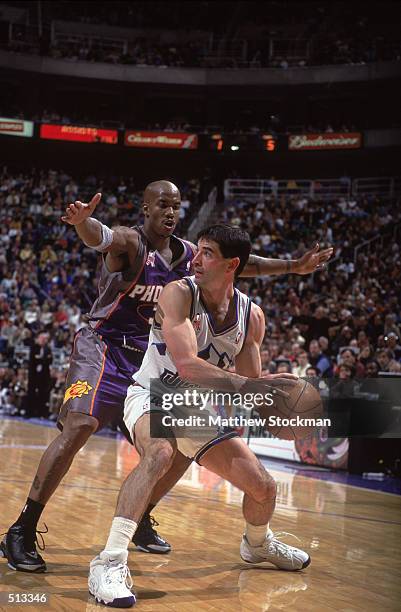 John Stockton of the Utah Jazz looks to move the ball as he is guarded by Stephon Marbury of the Phoenix Suns during the game at the Delta Center in...