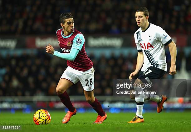 Manuel Lanzini of West Ham United takes on Kevin Wimmer of Tottenham Hotspur during the Barclays Premier League match between West Ham United and...