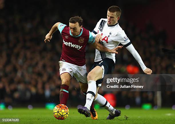 Mark Noble of West Ham United and Eric Dier of Tottenham Hotspur challenge for the ball during the Barclays Premier League match between West Ham...