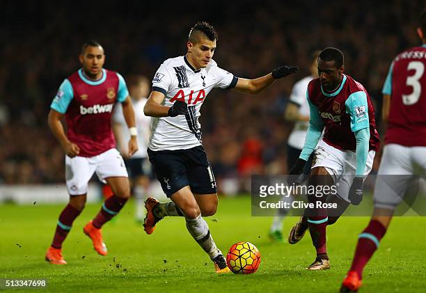 Erik Lamela of Tottenham Hotspur runs with the ball at Pedro Mba Obiang of West Ham United during the Barclays Premier League match between West Ham...
