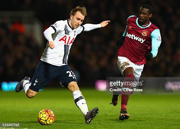 Christian Eriksen of Tottenham Hotspur takes on Pedro Mba Obiang of West Ham United during the Barclays Premier League match between West Ham United...