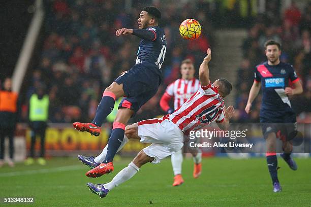 Jamaal Lascelles of Newcastle United jumps for the ball with Jonathan Walters of Stoke City during the Barclays Premier League match between Stoke...