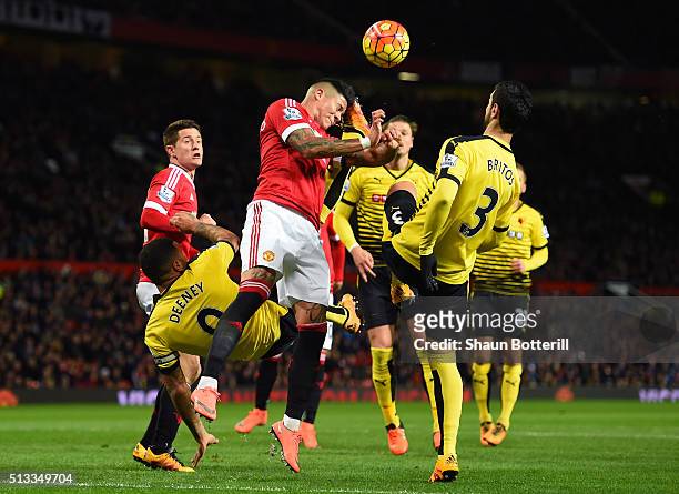 Marcos Rojo of Manchester United battles with Troy Deeney and Miguel Angel Britos of Watford during the Barclays Premier League match between...