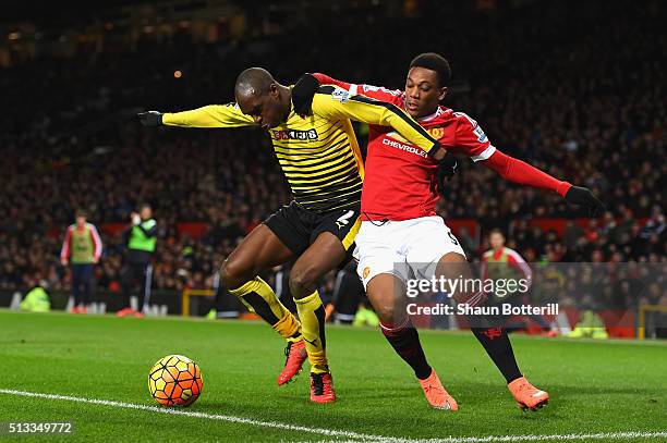 Allan-Romeo Nyom of Watford and Anthony Martial of Manchester United battle for the ball during the Barclays Premier League match between Manchester...