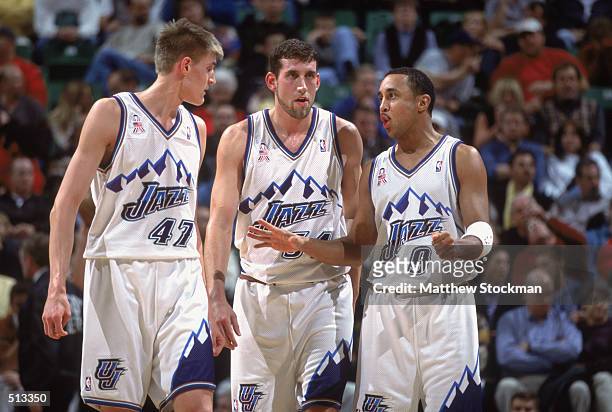 John Starks of the Utah Jazz walks with teammates Scott Padgett and Andrei Kirilenko during the game against the Phoenix Suns at the Delta Center in...