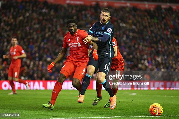 Kolo Toure of Liverpool and Aleksandar Kolarov of Manchester City battle for ball during the Barclays Premier League match between Liverpool and...