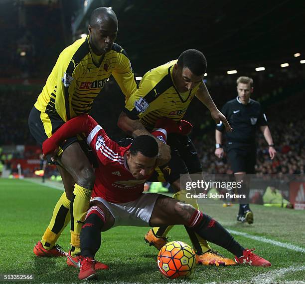 Memphis Depay of Manchester United in action with Allan Nyom and Troy Deeney of Watford during the Barclays Premier League match between Manchester...