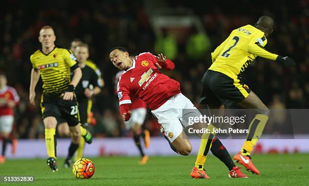 Memphis Depay of Manchester United in action with Allan Nyom of Watford during the Barclays Premier League match between Manchester United and...