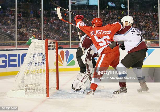 Tomas Holmstrom of the Red Wings Alumni team fights for position against Greg de Vries of the Colorado Avalanche Alumni team at the 2016 Coors Light...