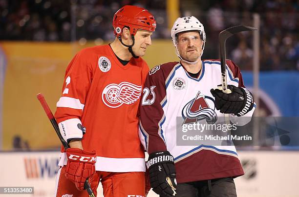 Milan Hejduk of Colorado Avalanche Alumni team talks with Jiri Fischer of the Red Wings Alumni team at the 2016 Coors Light Stadium Series at Coors...