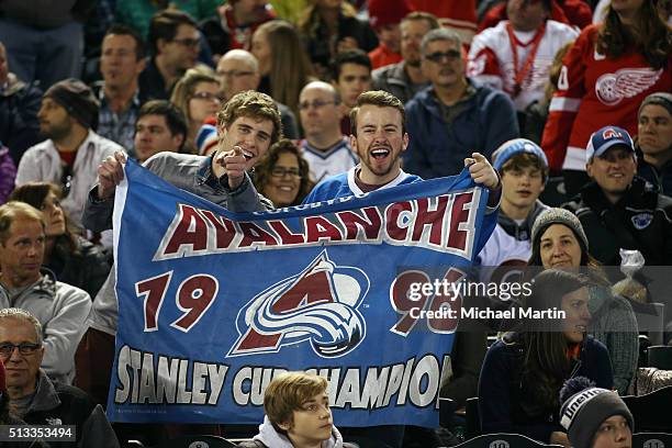 Fans of the Colorado Avalanche Alumni team hold a flag during the game against the Red Wings Alumni team at the 2016 Coors Light Stadium Series at...