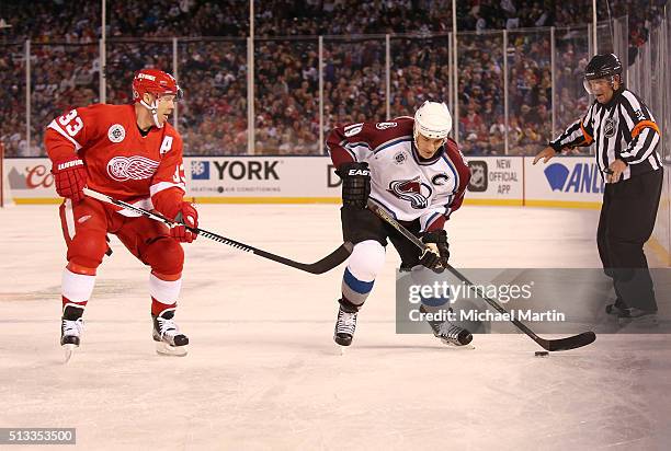 Joe Sakic of the Colorado Avalanche Alumni team skates against Kris Draper of the Red Wings Alumni team at the 2016 Coors Light Stadium Series at...