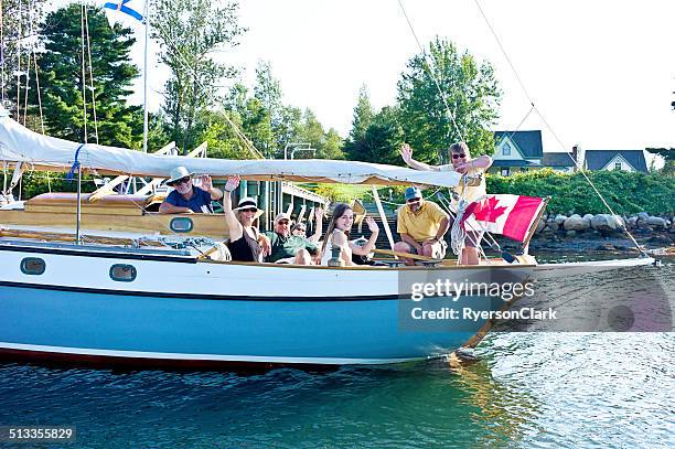 family sailing on mahone bay nova scotia - flag of nova scotia stock pictures, royalty-free photos & images