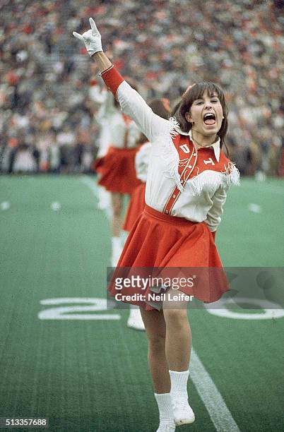 Texas cheerleader gesturing Hook'em Horns sign during game vs Arkansas at Razorback Stadium. Fayetteville, AR 12/6/1969 CREDIT: Neil Leifer