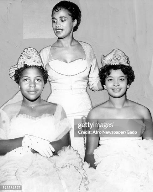 Jazz musician Harry Belafontes wife Marguerite Belafonte and Patricia Godbolt crowning a beauty pageant winner, Norfolk, Virginia, October 24, 1959....