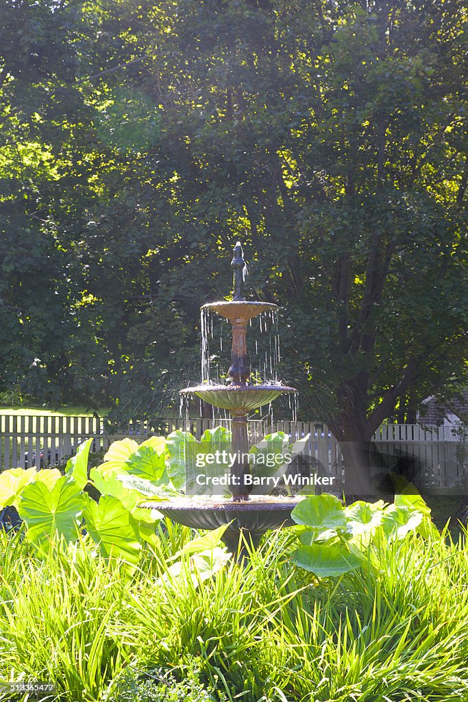 Slow-flowing water in tiered garden fountain