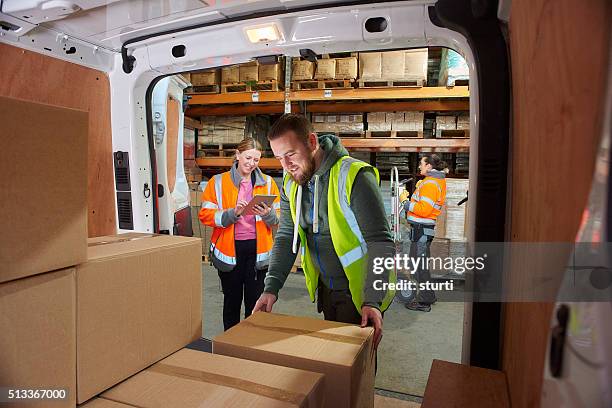 livraison conducteur dans le entrepôt - camion de livraison photos et images de collection