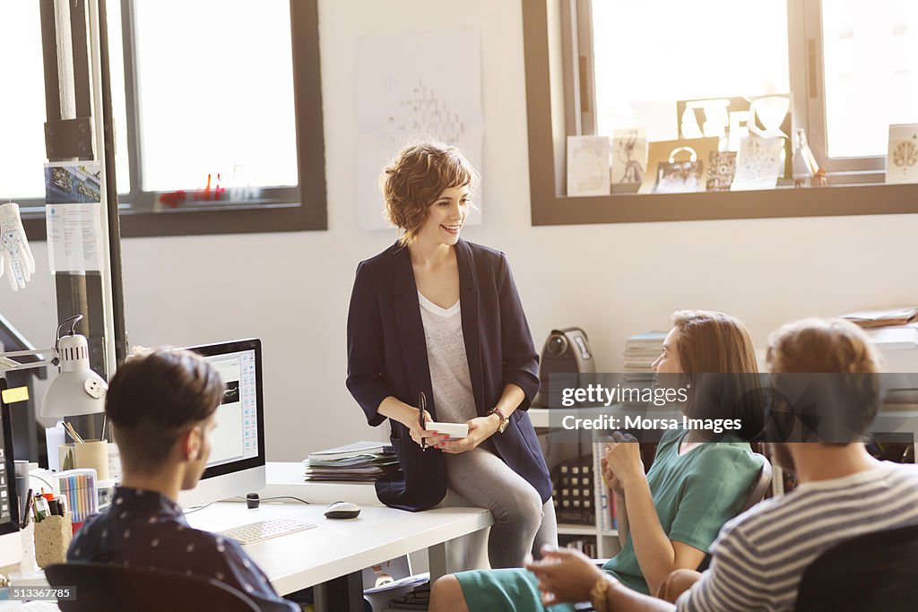 Colleagues discussing in office