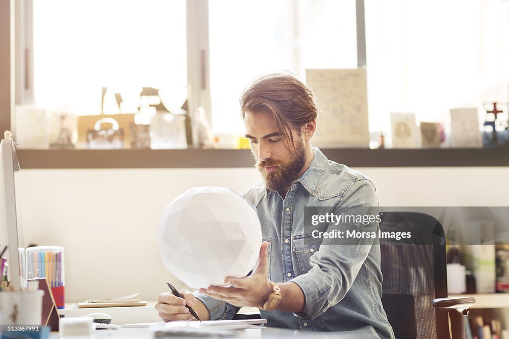 Businessman examining model