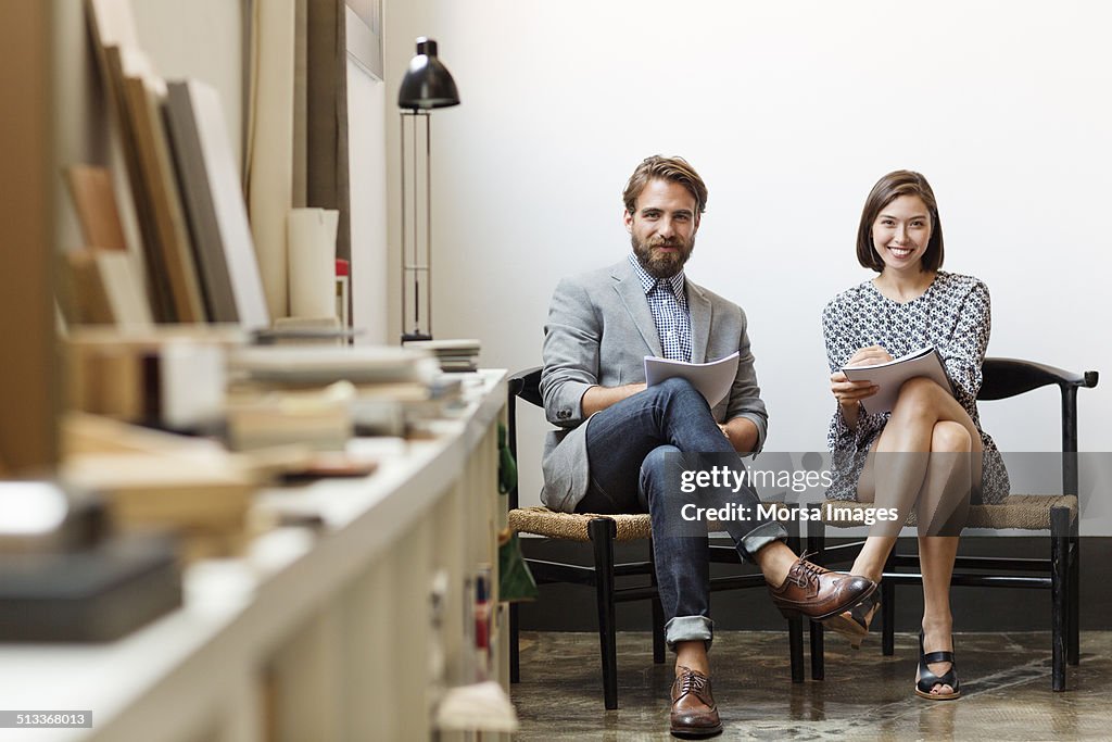 Confident business colleagues sitting in office