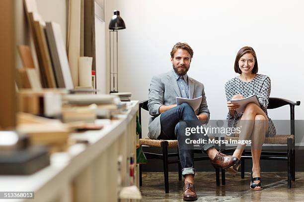 confident business colleagues sitting in office - 2 men woman imagens e fotografias de stock