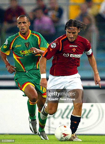Francesco Totti of Roma moves the ball past Guillermo Giacomazzi of Lecca during the Italian Serie A match between Lecce v Roma September 22, 2004 at...