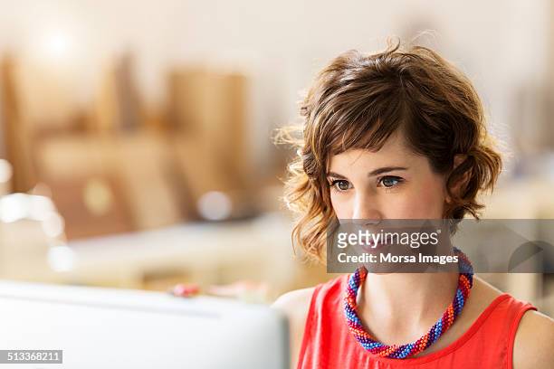 businesswoman using computer in office - business concentration stock pictures, royalty-free photos & images