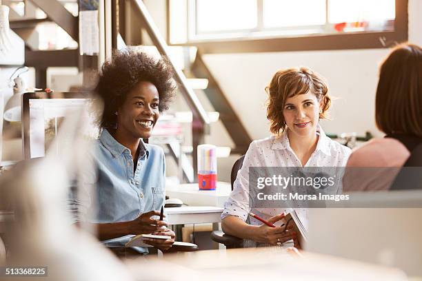 happy businesswomen in office - tres amigos fotografías e imágenes de stock