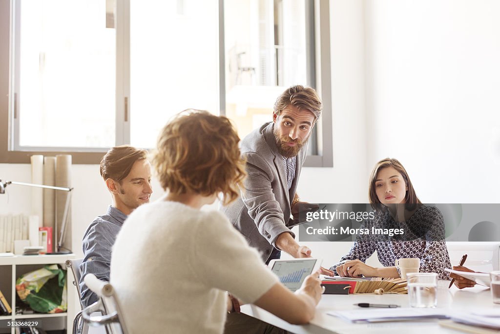 Confident businessman in board room meeting