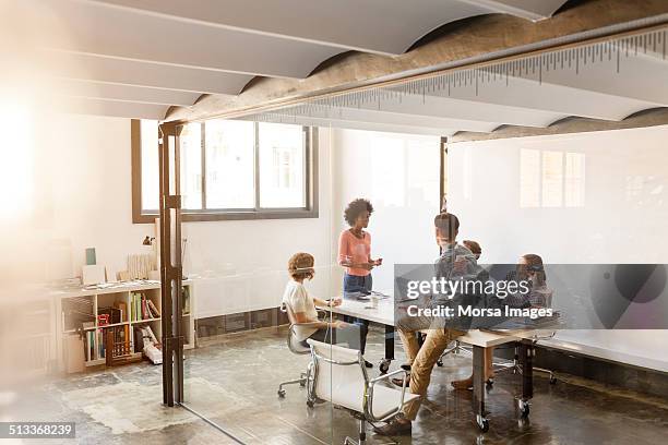 business colleagues discussing in board room - leanincollection man stock pictures, royalty-free photos & images