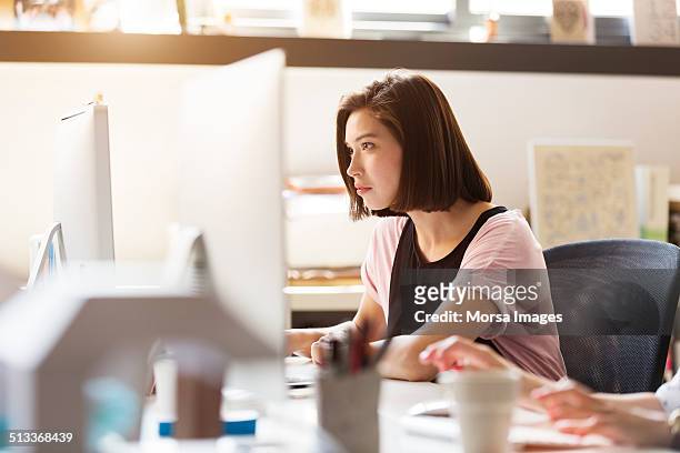 businesswoman using computer - image focus technique stock pictures, royalty-free photos & images