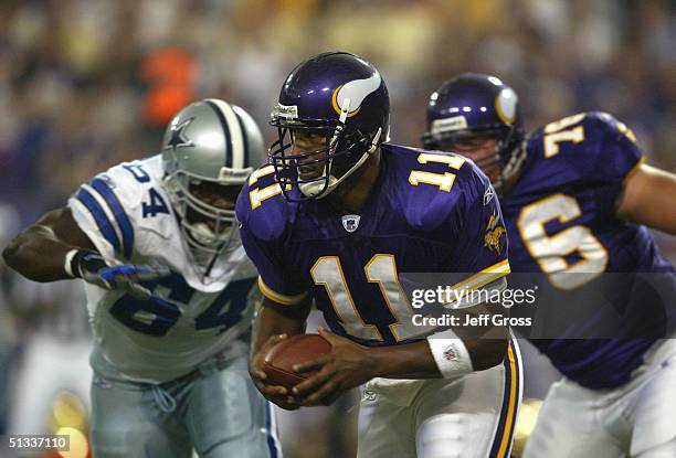 Daunte Culpepper of the Minnesota Vikings runs with the ball against the Dallas Cowboys on September 12, 2004 at the Hubert H. Humphrey Metrodome in...