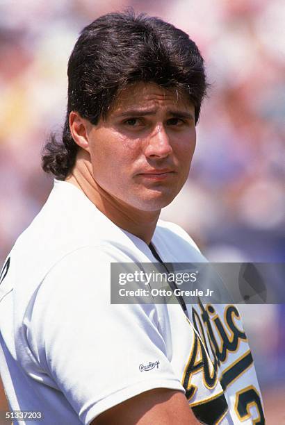 Jose Canseco of the Oakland Athletics looks on during a 1990 MLB season game at Oakland-Alameda County Coliseum in Oakland, California.