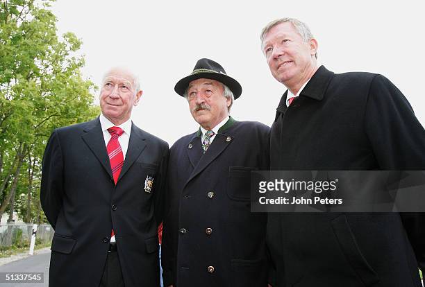 Sir Bobby Charlton and Sir Alex Ferguson of Manchester United pose with Georg Fischer, a fireman who attended the Munich Air Crash on his first day...
