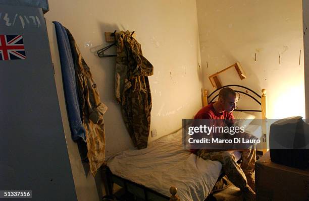 British army soldier from the 1st Cheshire Regiment plays video games at his base at the Old State Building September 22, 2004 in Basrah which is...